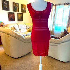 Bebe Sexy figure hugging dress with cutouts.